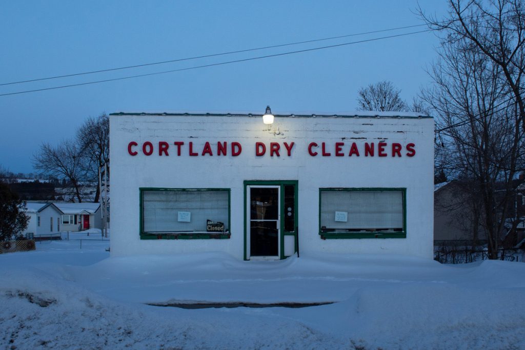 Lillian Lickona • <em>Cortland Dry Cleaners at Dusk</em> • NFS