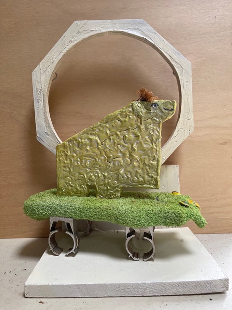 Mary Ann Bowman • <em>Now I’m wondering where my other green frog sock is</em> • Wood, green sock • 12″×19″×8″ • $475.00