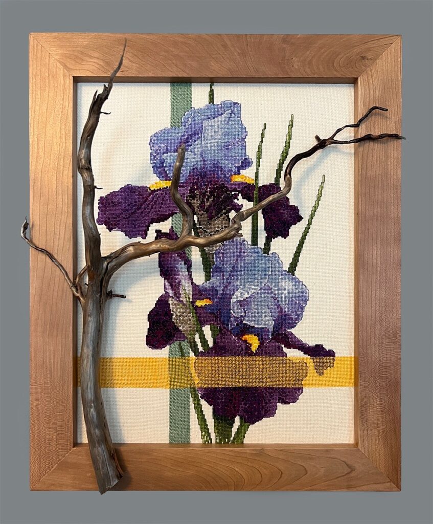 Eva M. Capobianco • <em>Purple Iris with Branch</em> • Cross stitch, found wood • 14″×17″×6″ • $425.00