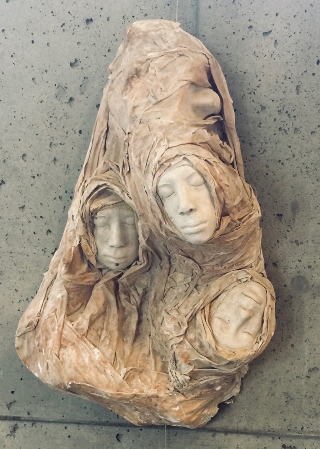 Nicholas Carbonaro • <em>Refugee </em> • Ceramic masks, cotton fabric, plaster, water color, metal wire • 33″×23″×13″ • $3,500.00<a class="purchase" href="https://state-of-the-art-gallery.square.site/product/nicholas-carbonaro-refugee/787" target="_blank">Buy</a>
