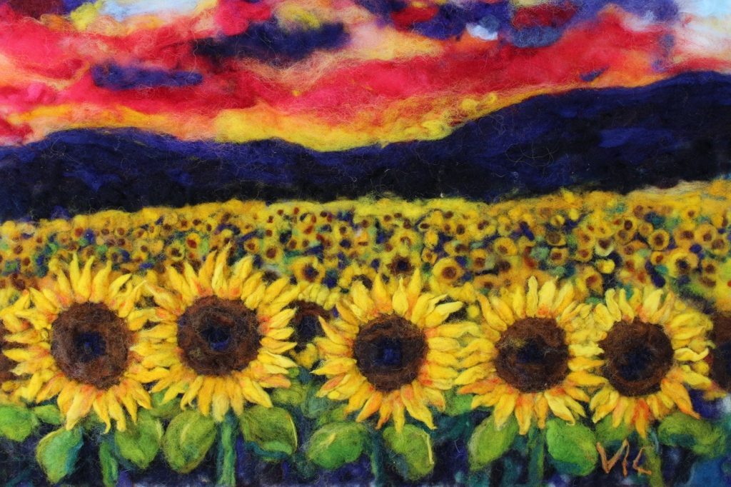 Victoria Connors • <em>Sunflower sundown </em> • Wool, felt, fine fibers, beads.  • 24″×28″ • $1,200.00<a class="purchase" href="https://state-of-the-art-gallery.square.site/product/victoria-connors-sunflower-sundown/776" target="_blank">Buy</a>