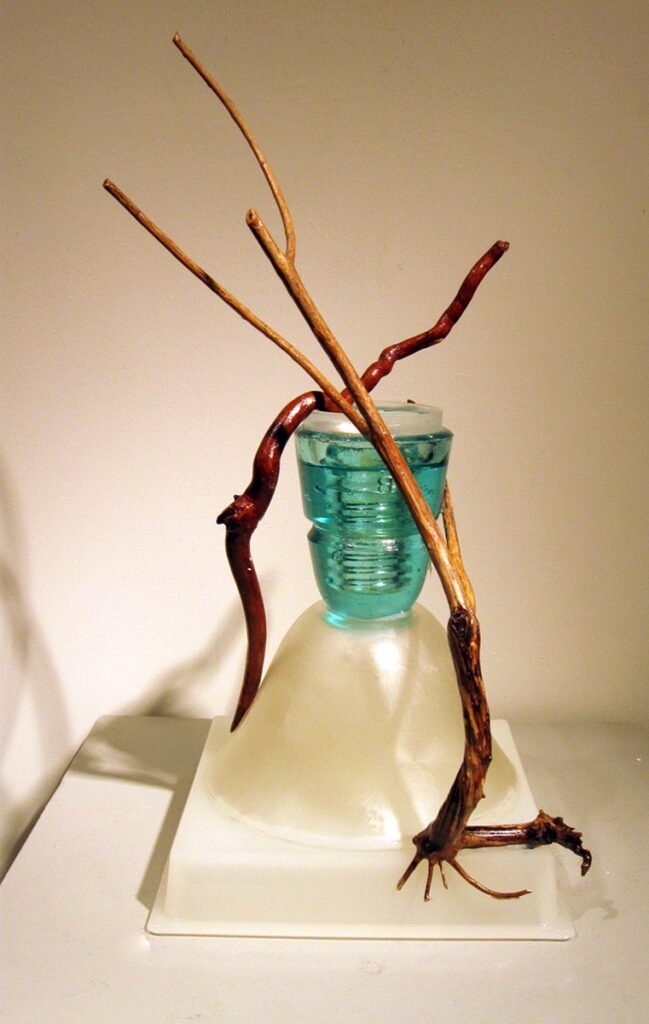 Eva M. Capobianco • <em>Blue Glass Trophy</em> • Found glass and wood • 9″×17″×8″ • $275.00