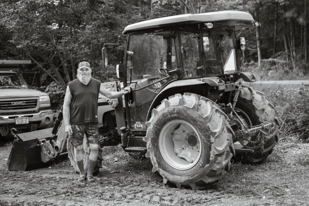 Susan C. Larkin • <em>Delmar and his Tractor</em> • Archival digital print • 24″×18″ • $300.00