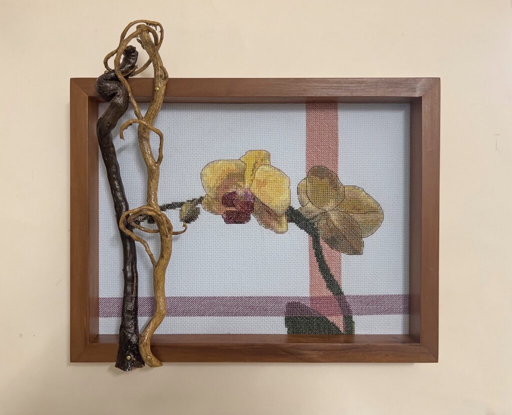 Eva M. Capobianco • <em>Orchids with Branch and Vine</em> • Cross stitch, found and reused wood • 13″×12″×3″ • $175.00