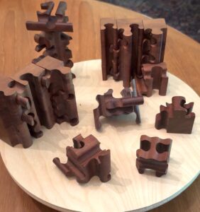 Frances L. Fawcett • <em>Cube Puzzle with 3-D Cuts</em> • Mahogany • 12″× 5″× 12″ • NFS