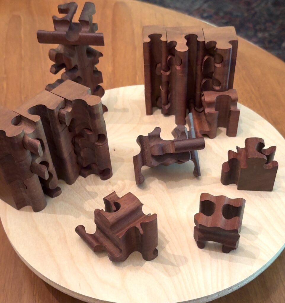 Frances L. Fawcett • <em>Cube Puzzle with 3-D Cuts</em> • Mahogany • 12″× 5″× 12″ • NFS