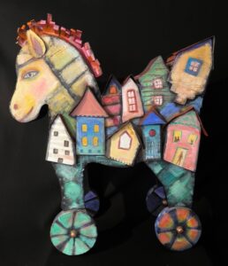 Jane Dennis&nbsp;• <em>Trojan Trojan Horse Grows Into Neighborhood Housing</em>&nbsp;• Mixed media&nbsp;• 22″×&nbsp;26″×&nbsp;8″&nbsp;• $800.00<a class="purchase" href="https://state-of-the-art-gallery.square.site/product/jane-dennis-trojan-trojan-horse-grows-into-neighborhood-housing/KGYQOSVK3B2S7U4GMCACKO6W" target="_blank">Buy</a>