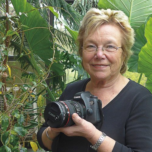 Nancy V. Ridenour in greenhouse with camera